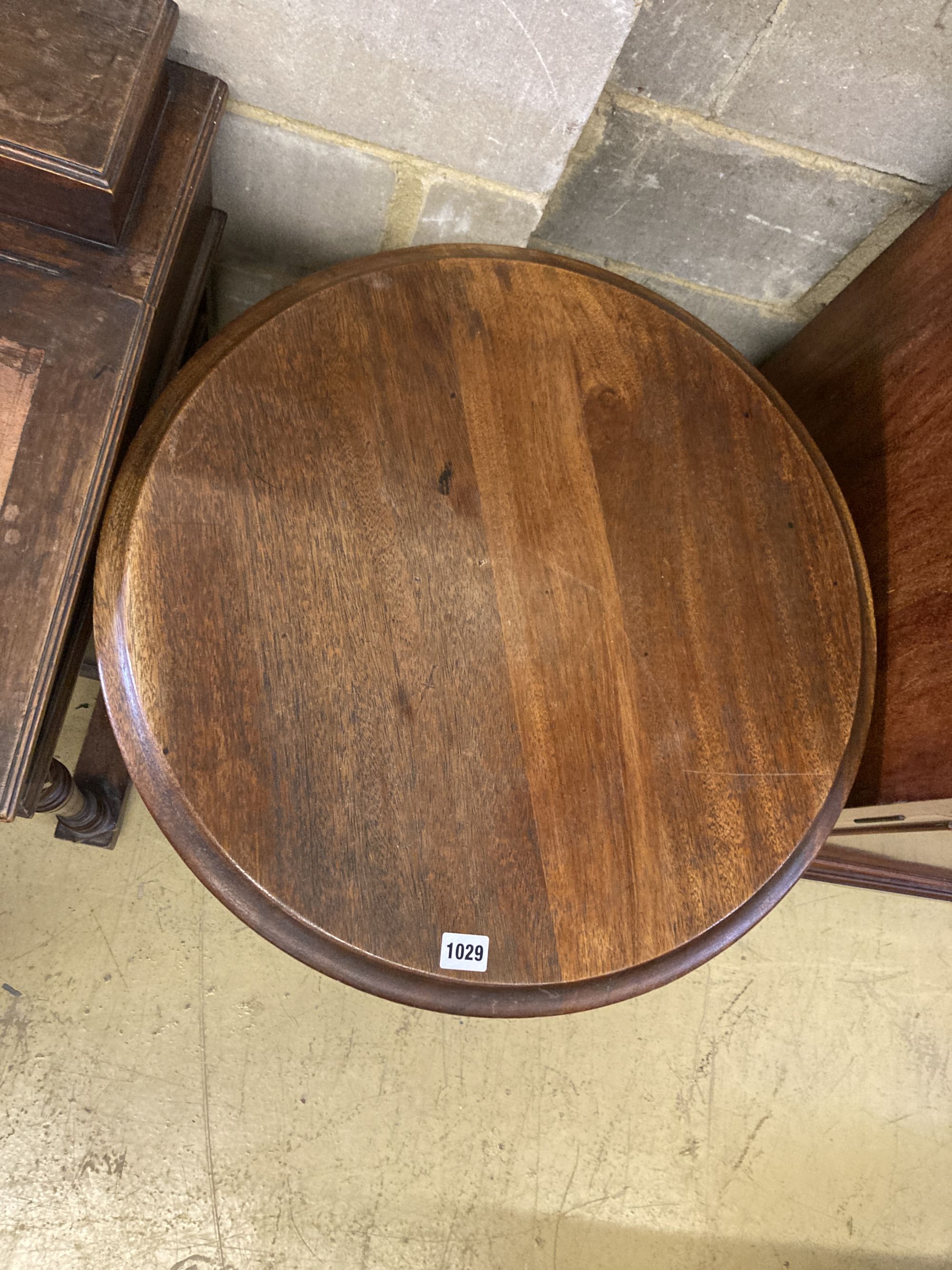 A Victorian style cast iron circular mahogany topped table, 58cm diameter, height 72cm